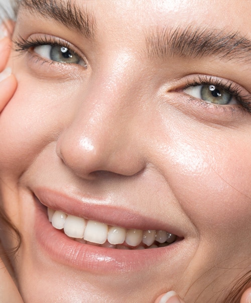 stock image of Close up studio shot of a beautiful woman with perfect skin, she touching her face