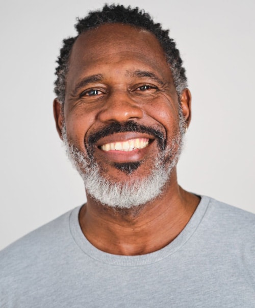 stock image of a confident middle aged Dominican man with a grey t-shirt