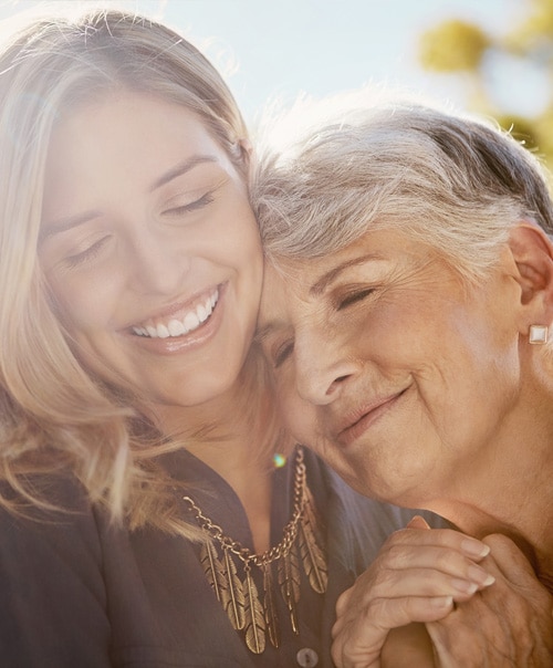 stock image of happy senior woman spending quality time with her daughter outdoors