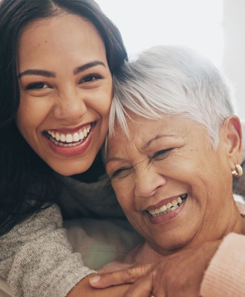 stock image smile of happy woman and senior mother embracing in apartment together